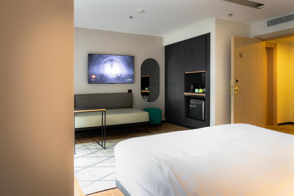 Postel nebo postele na pokoji v ubytování מלון אבא תל-אביב-יפו