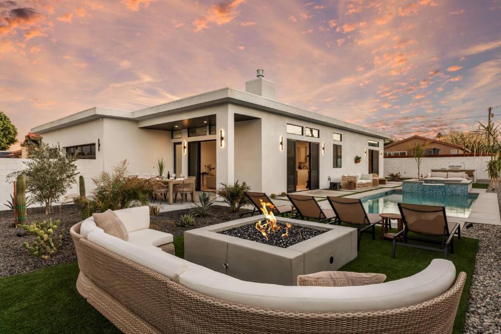 a house with a fire pit in the yard at Desert Oasis: Pool, Spa, Golf Sim + EV Charger in Bermuda Dunes