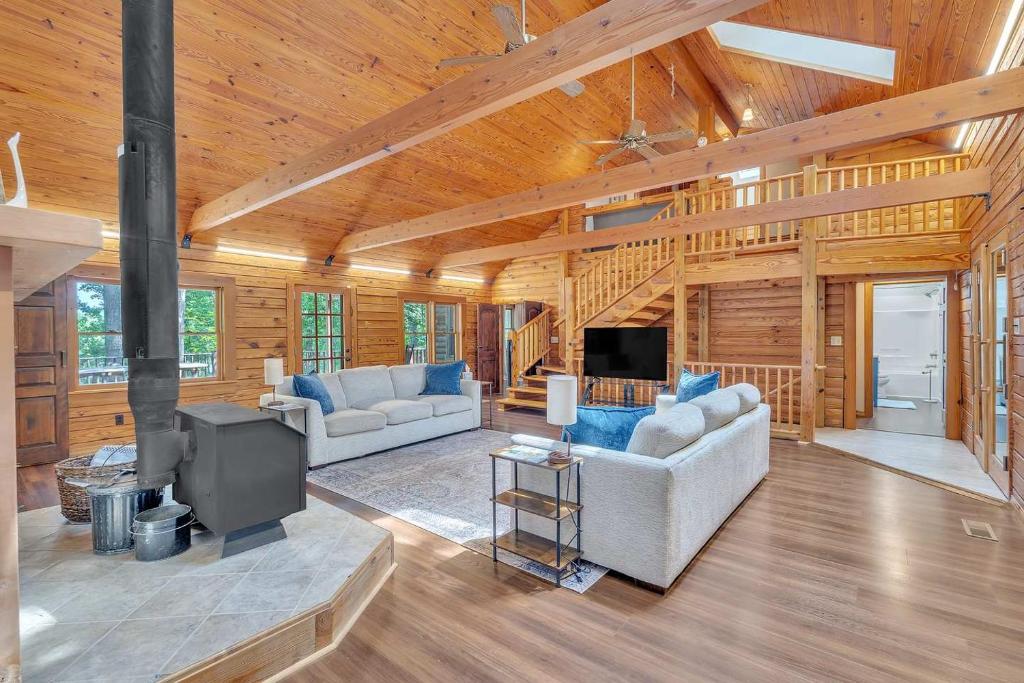 a living room with two couches and a tv at Gorgeous Lakefront Escape - New Renovations in Mineral