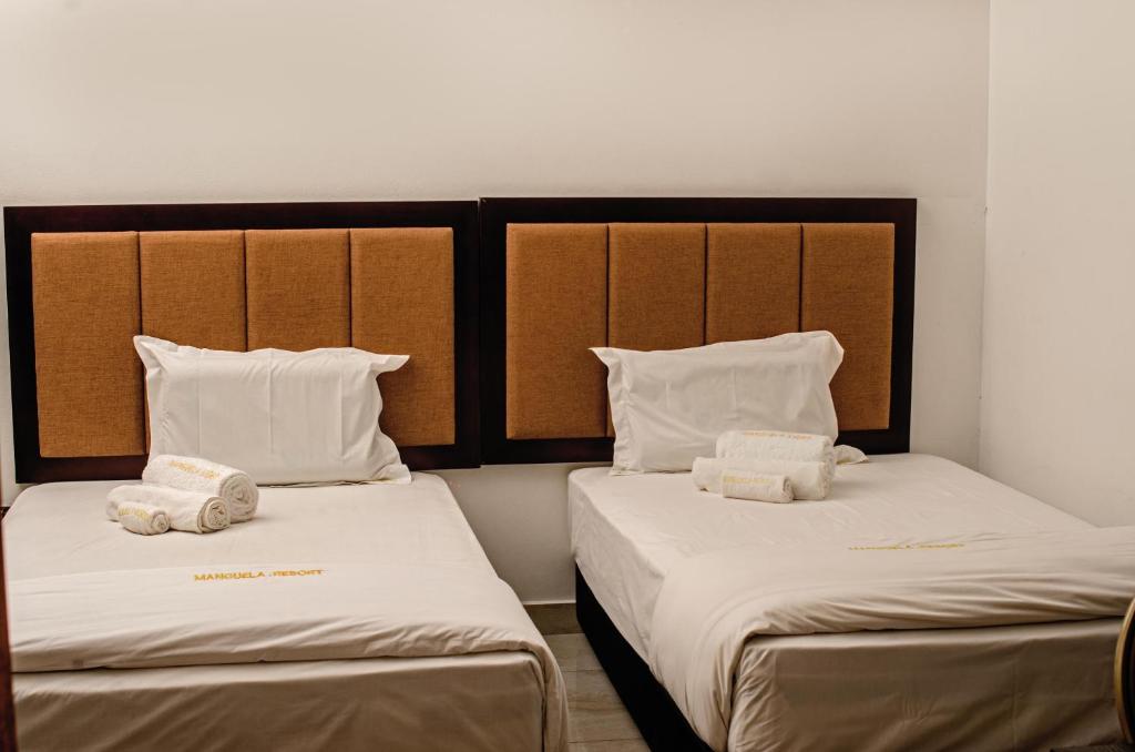 Giường trong phòng chung tại Manguela Light