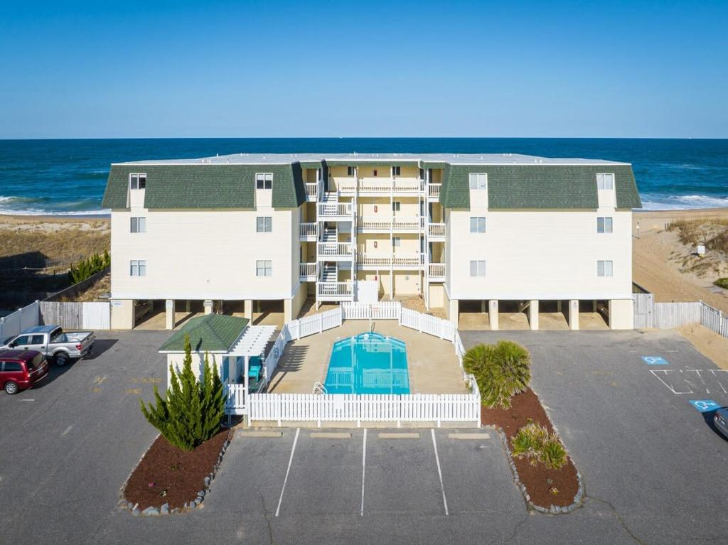 an aerial view of a building at the beach at Beachfront Condo with Ocean Views and Pool Access in Kill Devil Hills