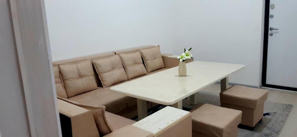 a living room with a table and a couch at City Center Apartment "Afsona mall" in Irvadan