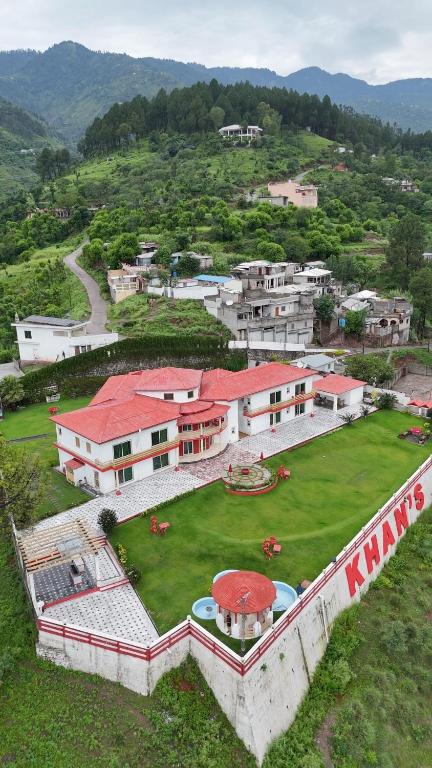 an aerial view of a large building with a yard at Highland Club Balakot in Bālākot