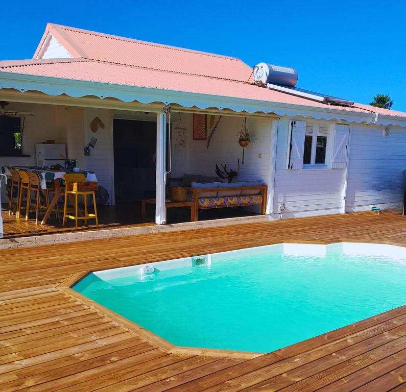 a swimming pool on the deck of a house at Villa La Kaz a Gwada in Port-Louis