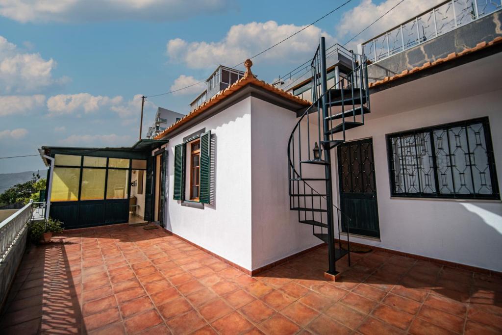 una casa blanca con una escalera al frente en Ferienhaus Treibholz, en Funchal