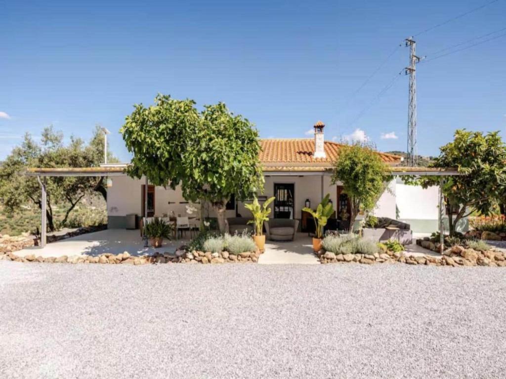 a house with a gravel driveway in front of it at 5-Bedroom Villa with Pool, Swimjet and Jacuzzi in Comares
