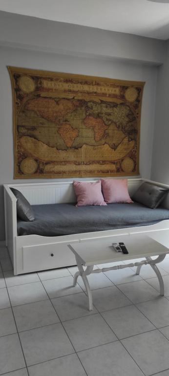 a bed with pink pillows and a wooden wall at Parastaseis City Apartment Central in Patra