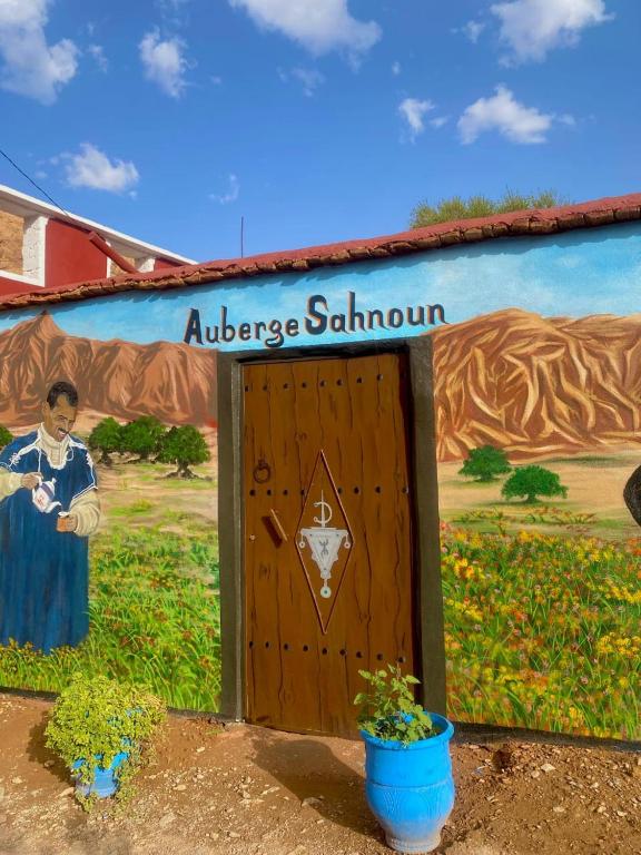 a mural on the side of a building with a door at Auberge sahnoun in Tafraout