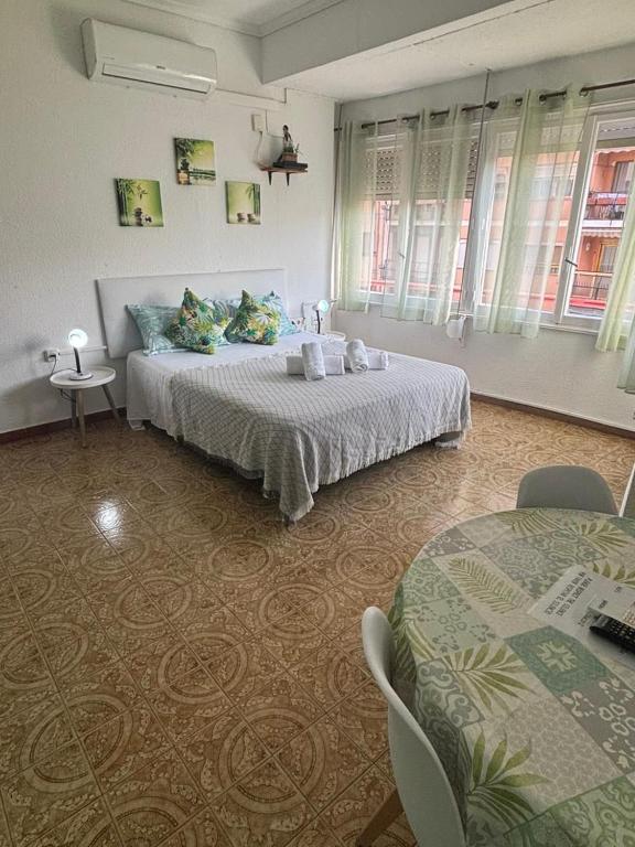 a bedroom with a bed and two tables in it at Donatella Guesthouse Alicante in Alicante