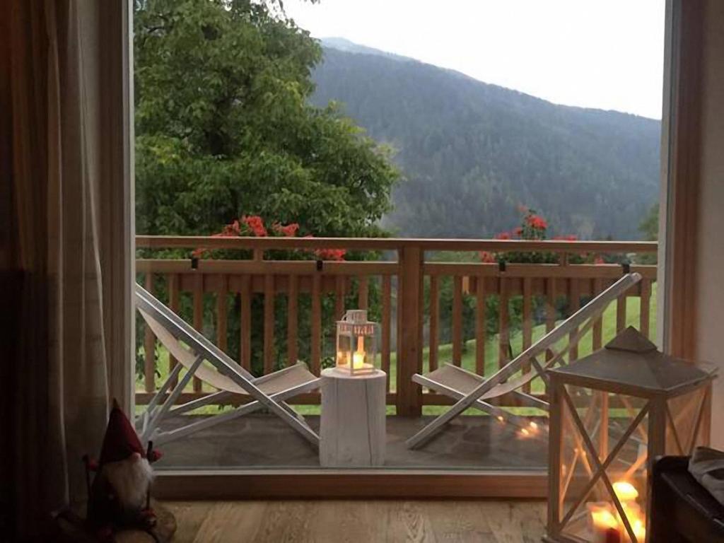 a room with a balcony with a view of a mountain at Dolomiti di Brenta House 2 in Madonna di Campiglio
