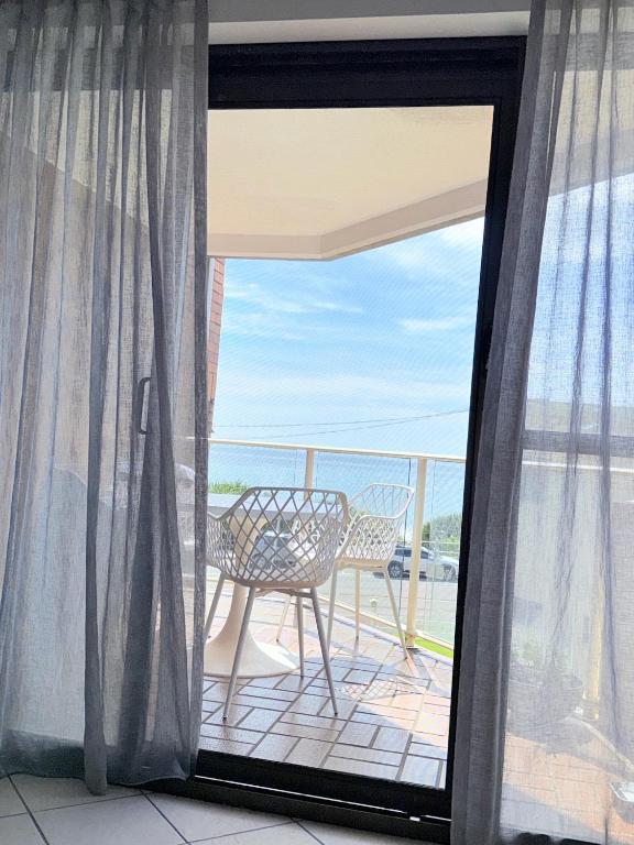 a balcony with a table and a chair at 2Bdr Beachfront Apartment - First Bay Coolum in Coolum Beach