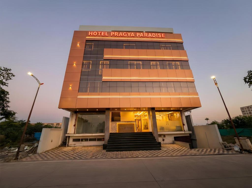 a hotel pharmacy building with stairs in front of it at Hotel Pragya Paradise in Indore