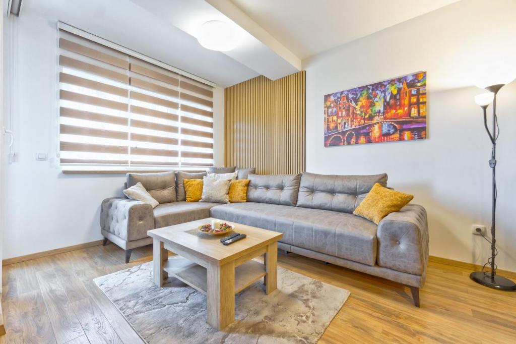 a living room with a couch and a table at Avantura apartman 14 in Zlatibor