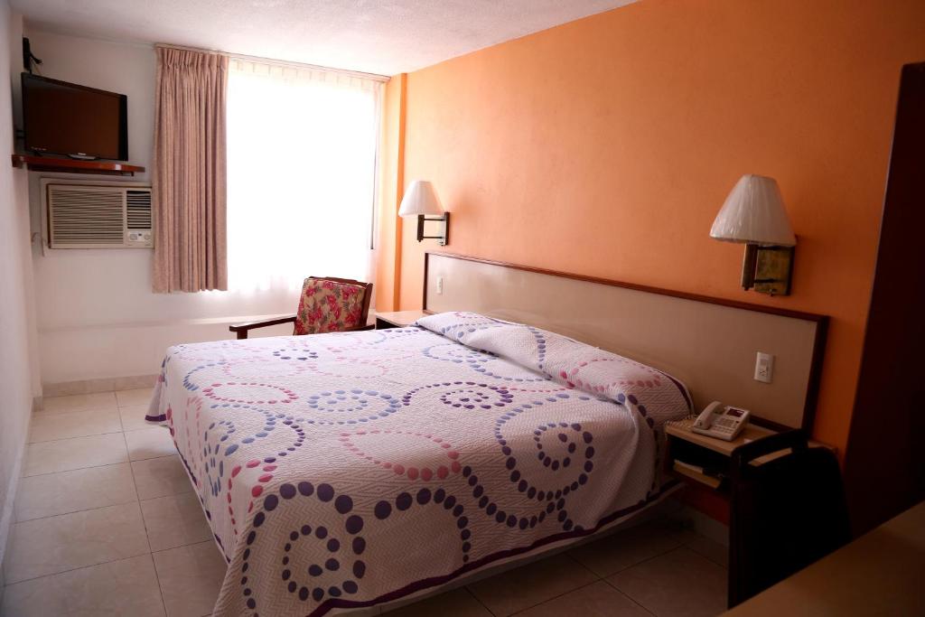 Postel nebo postele na pokoji v ubytování Hotel Baluarte