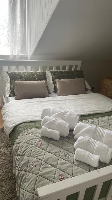 a large bed with white sheets and pillows on it at Anyas rooms Ltd in Antrim
