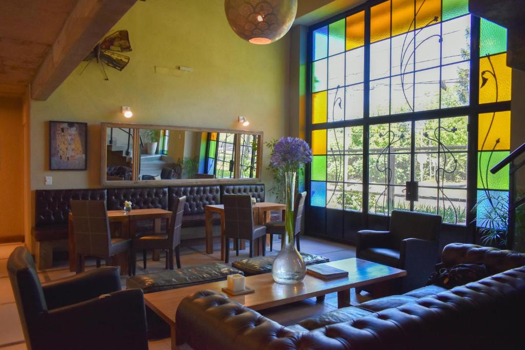 a restaurant with a table and chairs and stained glass windows at Hotel San Germán de Muñiz in Muñiz