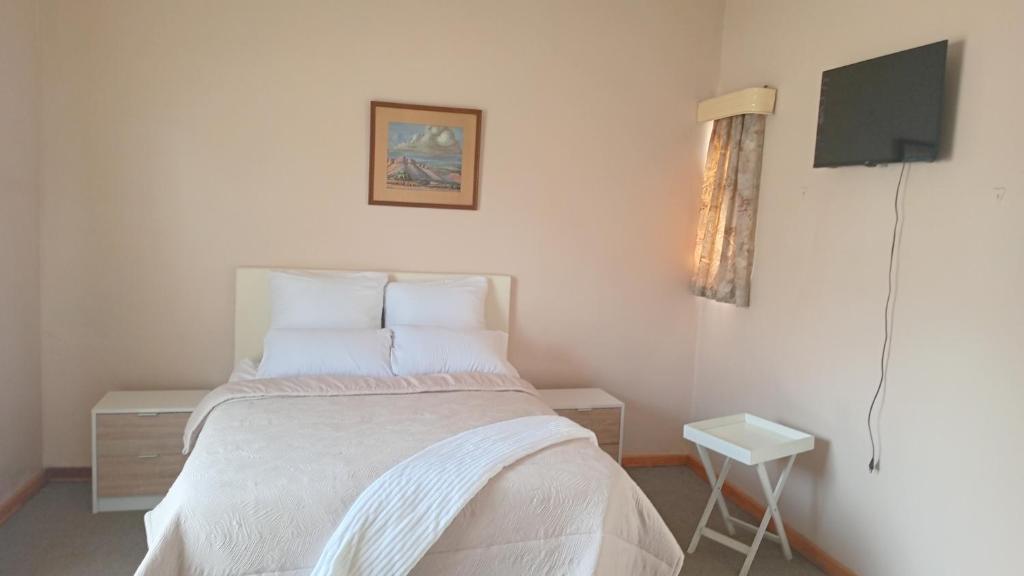 En eller flere senge i et værelse på SashMc Flair Guesthouse