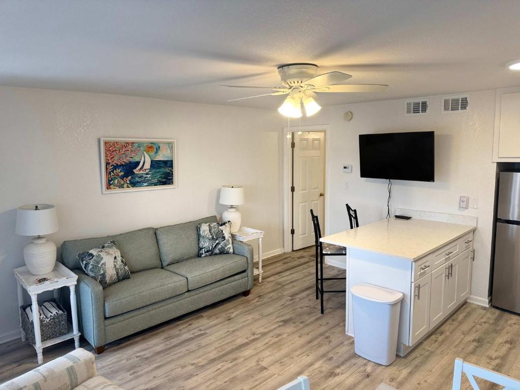 a living room with a couch and a table at Tropical Isle 209 w Convenient Beach Access in Fort Walton Beach