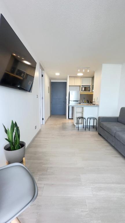 un soggiorno con divano e cucina di Departamento Concon Costa de Montemar a Concón