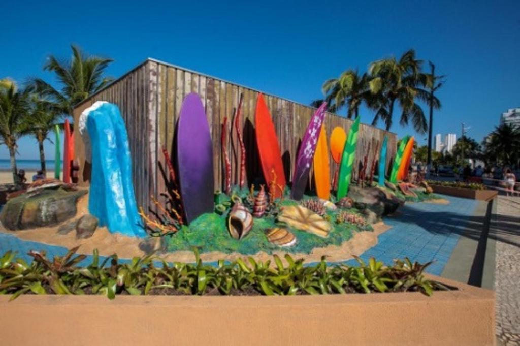 a display of surfboards in front of a fence at Badaró's Beach in Praia Grande