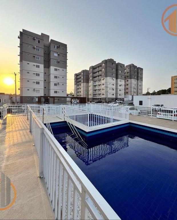 a swimming pool on top of a building with tall buildings at Ap Go travel in São Luís