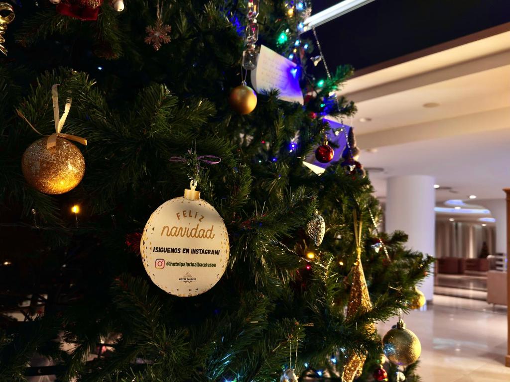 Uma árvore de Natal com um ornamento de Natal. em Hotel Palacio Albacete & SPA em Albacete