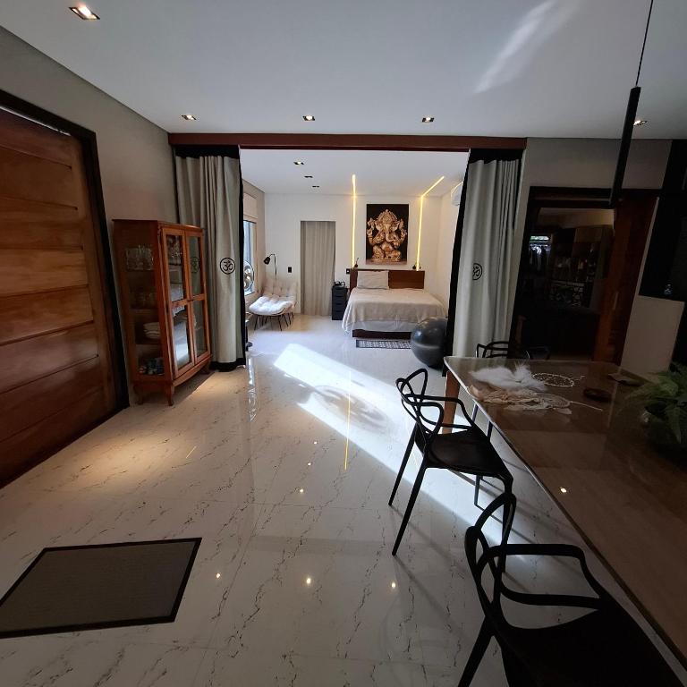 een woonkamer met een bed, een tafel en stoelen bij Natureza in Porto Seguro
