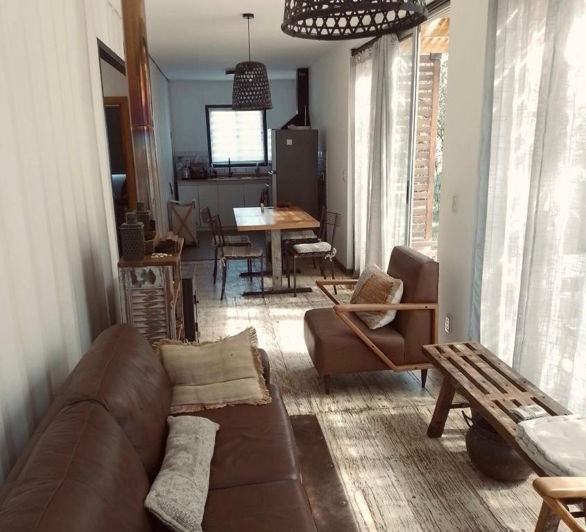 a living room with a couch and chairs and a table at La Pausa Container House in Manantiales