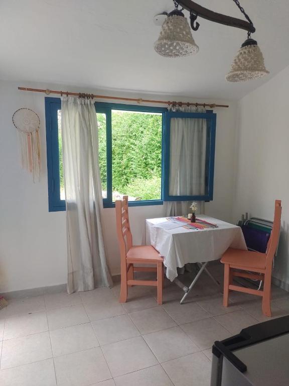 a dining room with a table and chairs and a window at La Calma in Los Reartes
