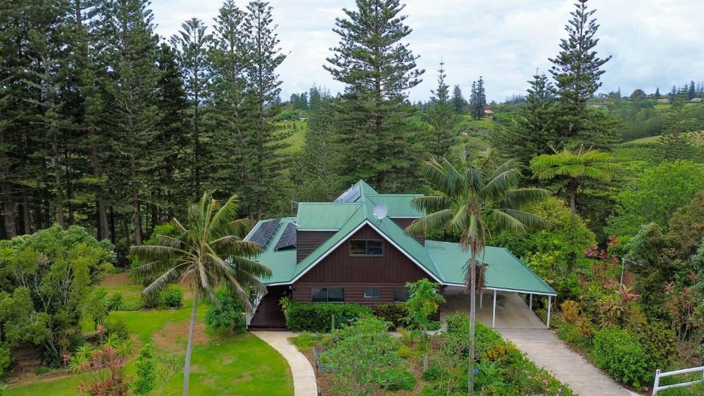 a house with a green roof and palm trees at Cascade View - 4 Bedroom House in Cascade