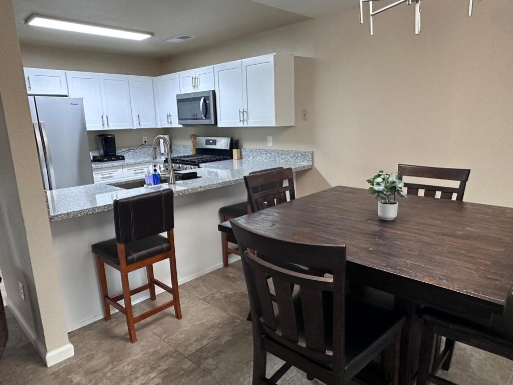 a kitchen and dining room with a table and chairs at Casa Cortez C in Visalia