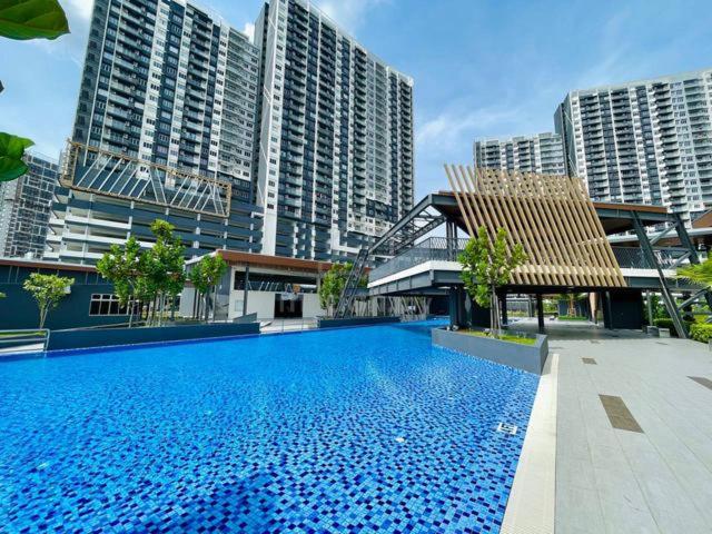 a large swimming pool in a city with tall buildings at 9 Beradik Homestay in Kajang