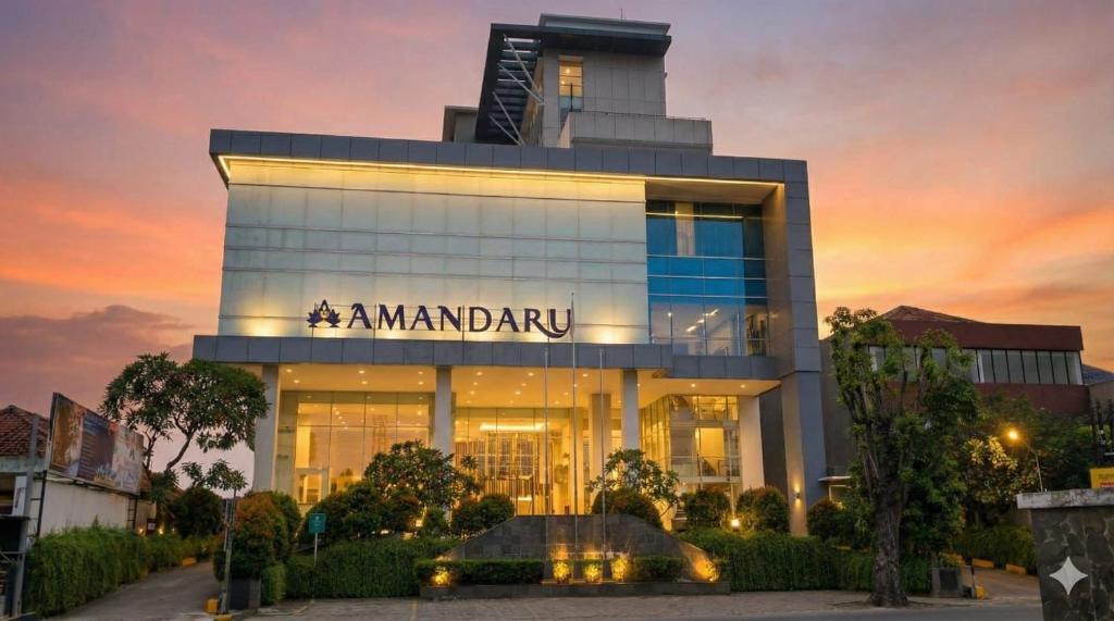 Un edificio con un cartel al costado. en Amandaru Hotel Pekalongan, en Pekalongan