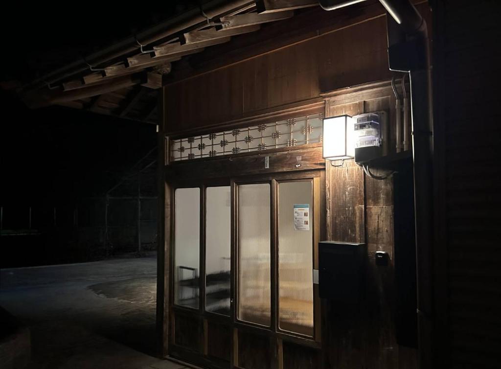 a building with a light on the side of it at SEN HAVEN Sakurai in Shingu