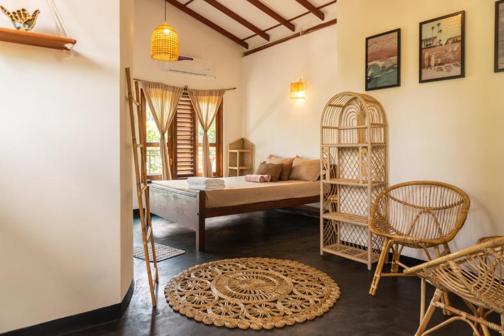 a room with a bed and a bird cage at Slow Life Boutique Hotel - Adults Only in Mirissa