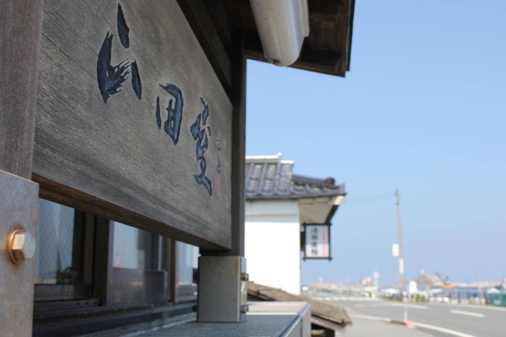 un panneau sur le côté d'un bâtiment dans l'établissement Yamadaya, à Tottori