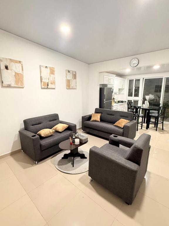 a living room with two couches and a table at Casa en San Miguel, el salvador in San Miguel