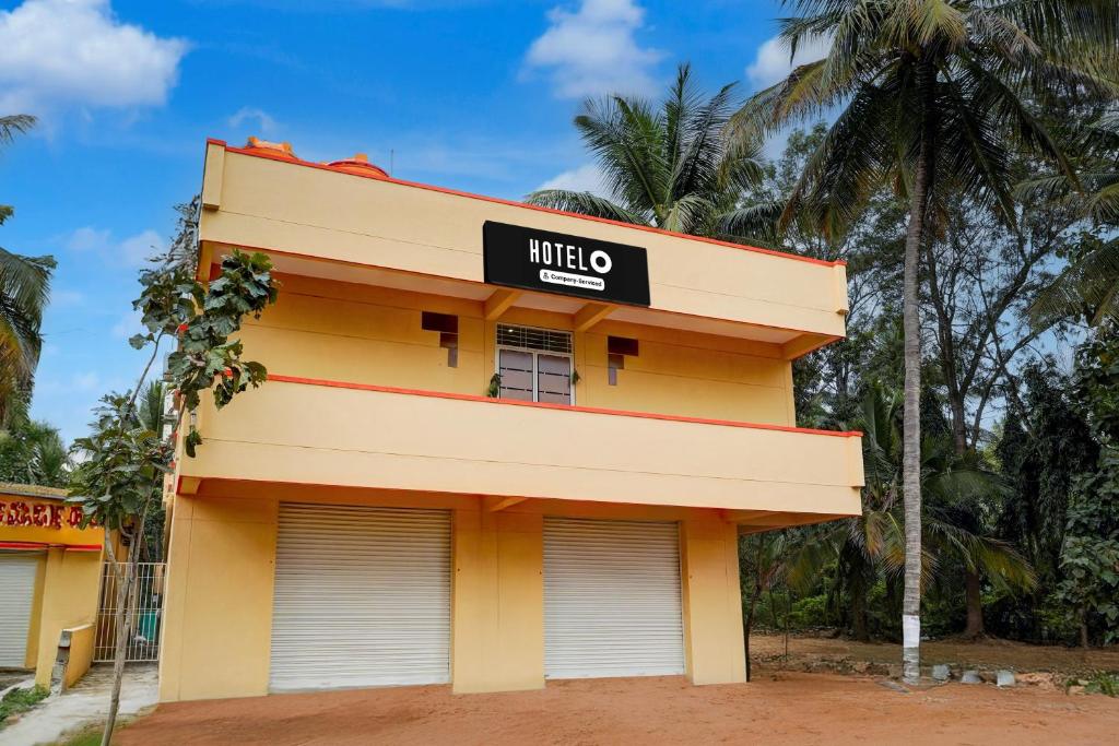 a yellow building with a mitzo sign on it at Hotel O Bidadi Railway Junction Bangalore Formerly Ejalla in Bidadi