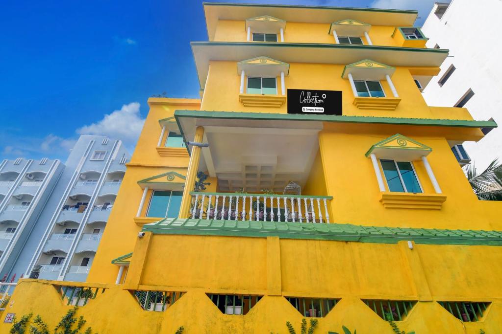 a yellow building with a sign on it at Super Collection O Puri Seaview Formerly Hotel Aavaas in Puri