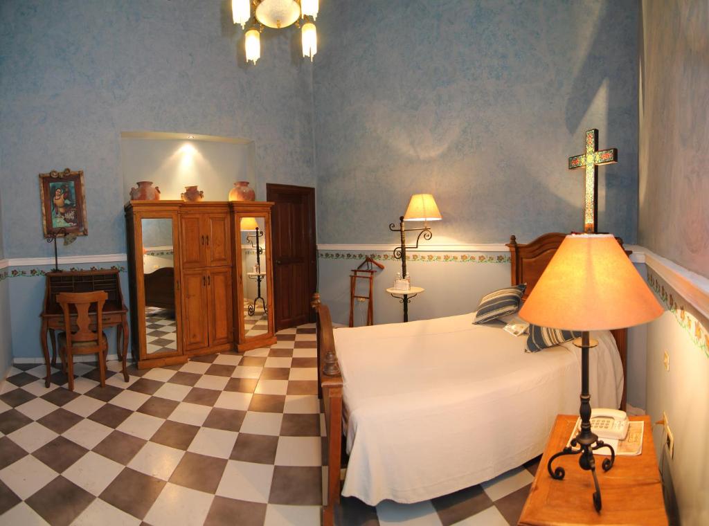 Postel nebo postele na pokoji v ubytování Hotel Boutique La Mision De Fray Diego