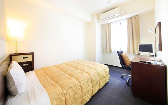 Postel nebo postele na pokoji v ubytování Fuchu Urban Hotel Annex