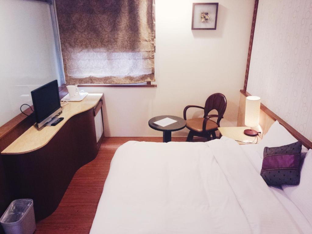 Postel nebo postele na pokoji v ubytování 玉泉旅館