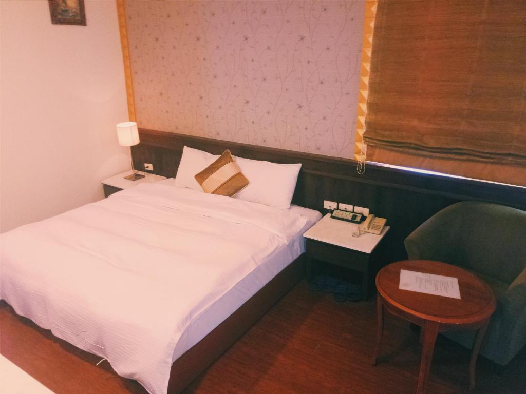 Postel nebo postele na pokoji v ubytování 玉泉旅館