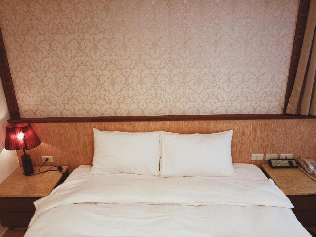 Postel nebo postele na pokoji v ubytování 玉泉旅館
