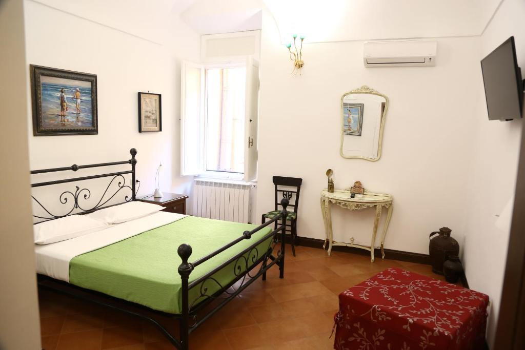 a bedroom with a bed and a table and a mirror at Antica Dimora in Orbetello