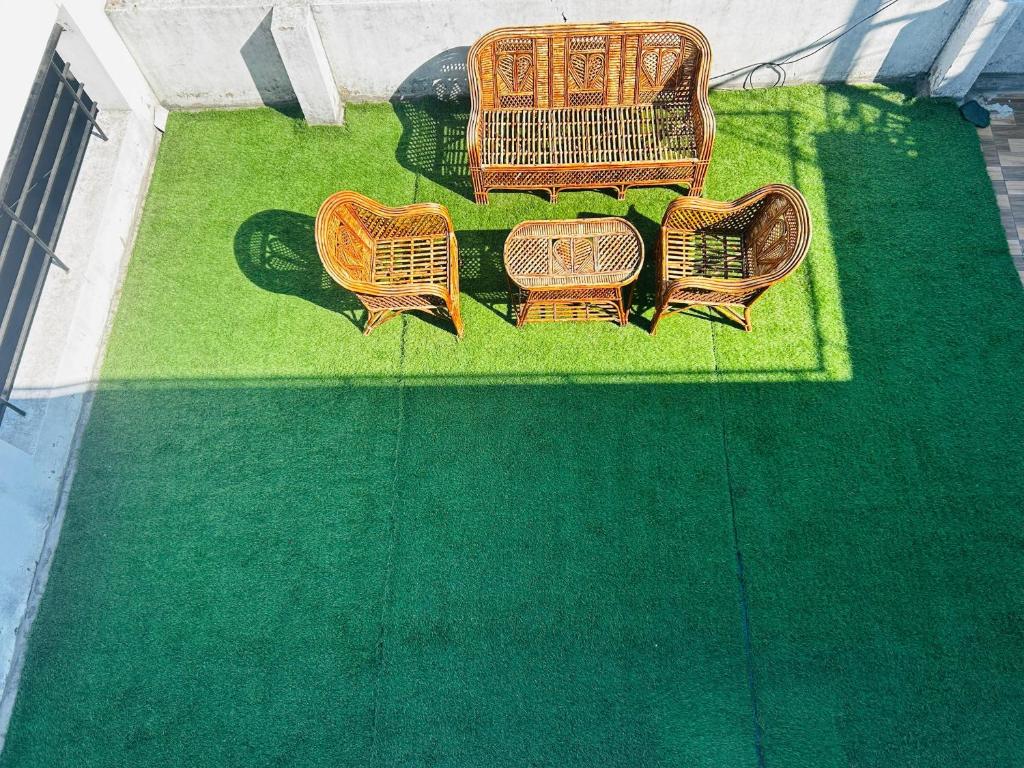 a group of four wicker chairs sitting on a lawn at Shree Ram Home Stay in Ujjain