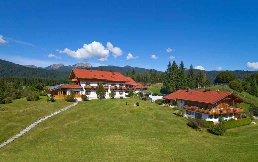 an overhead view of a house on a green field at Landhotel zum Bad in Krün