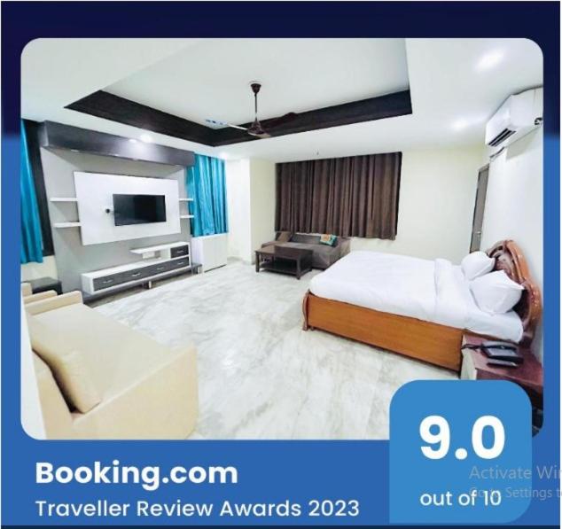 a hotel room with a bed and a tv at Hotel Birr Residency - Near Nizamuddin in New Delhi