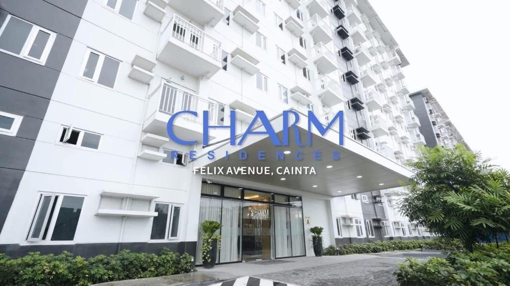 a building with a sign on the front of it at Aventura Presidential Suite at SMDC Charm Residences in Manila