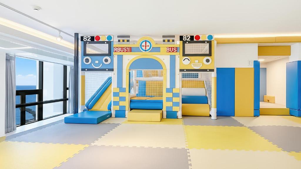 a childrens play room with a slide at Goseong Belossi Ayajin Kids Poolvilla in Goseong